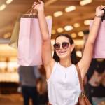 Excited, sale and happy woman with a shopping bag in mall for fashion, giveaway or discount. Portrait of rich customer person celebrate win with retail bags for product promotion, commerce and offer.