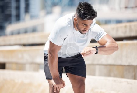 Photo for Man, fitness and checking watch after running exercise, cardio workout or training in city. Fit, active and sporty male person, athlete or runner looking at wristwatch for performance in urban town. - Royalty Free Image