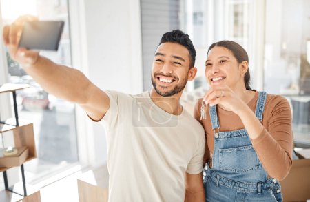 Photo for Selfie, new home and happy couple, keys and mortgage success, live stream apartment or real estate. Property investment, moving house and excited women with partner, photography and profile picture. - Royalty Free Image