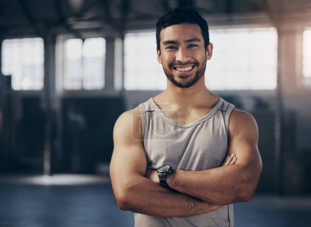 Photo for Fitness, smile and portrait of a personal trainer with crossed arms in the gym before a strength workout. Confidence, happy and male athlete after a bodybuilding arm exercise in a sports center - Royalty Free Image