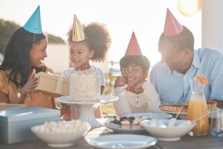Photo for Birthday, parents and children with cake in park for event, celebration and party outdoors together. Family, social gathering and mother, father with kids at picnic with cake, presents and surprise. - Royalty Free Image