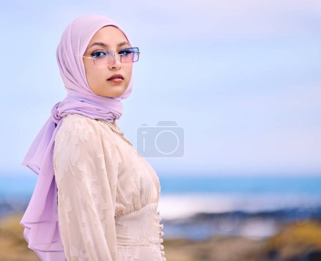 Photo for Portrait, fashion or sunglases with a muslim woman on mockup outdoor in a scarf for contemporary style. Islam, faith and hijab with an edgy young arab female person posing outside in modern eyewear. - Royalty Free Image