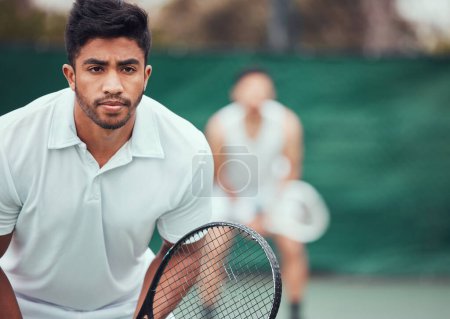 Photo for Male athlete, serious on tennis court for a competition with team and exercise in india. Man, racket and together for game at sports club in the outdoor for fitness with challenge to play in closeup - Royalty Free Image