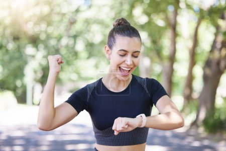 Photo for Success happy girl or runner with smartwatch in park for heart rate to monitor training or exercise progress. Excited, yes or healthy sports athlete with timer celebrates running workout or fitness. - Royalty Free Image