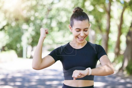 Photo for Success happy woman or runner with smartwatch in park for heart rate to monitor training or exercise progress. Excited, yes or healthy sports athlete with timer celebrates running workout or fitness. - Royalty Free Image