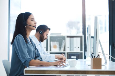 Call center, people and team in customer service, support or telemarketing on computer at the office. Woman and man consultant, agent or virtual assistant working for online agency at the workplace.