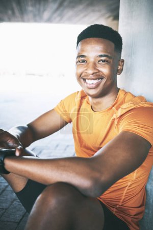 Photo for Another mile, another smile. Portrait of a young man looking at his watch during a workout against an urban background - Royalty Free Image