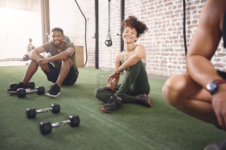 Photo for Were taking a break because we earned it. a fitness group resting after working out with dumbbells - Royalty Free Image