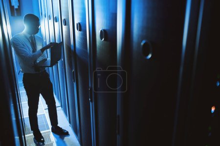 Photo for I specialise in digital security. a young man working in an IT server room - Royalty Free Image