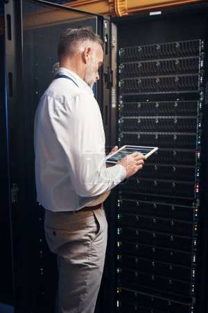Photo for Keeping the internet generation juiced up. a mature man using a digital tablet while working in a server room - Royalty Free Image