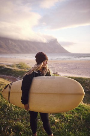 Téléchargez les photos : Vivre la vie d'un surfeur. une jeune femme séduisante surfant dans le désert - en image libre de droit