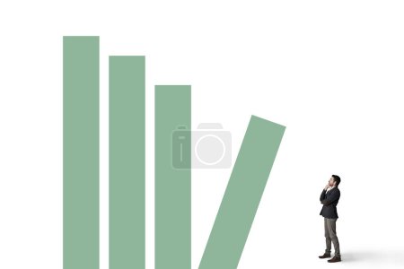 Photo for What goes up must come down. a businessman looking thoughtfully at a graph against a white background - Royalty Free Image
