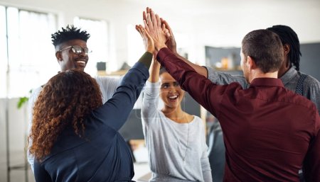 Photo for Success is what were going for together. a group of businesspeople high fiving together in an office - Royalty Free Image