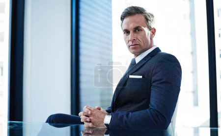 Photo for I make the rules around here. portrait of a successful businessman sitting at his desk in an office - Royalty Free Image