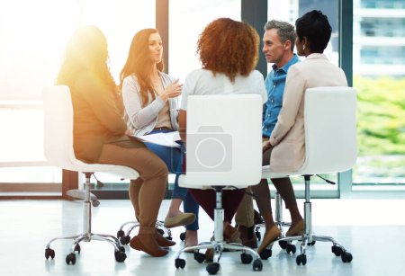 Photo for Giving 100 to their team task. a team of colleagues having a meeting in a modern office - Royalty Free Image
