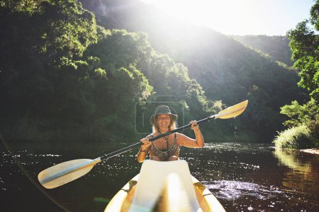 Photo for Itll be worth it, I promise. a young woman out kayaking on a lake - Royalty Free Image