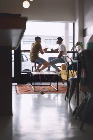 Photo for A good friend is someone whos always up for a coffee date. two young men talking while having coffee together in a cafe - Royalty Free Image