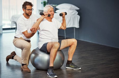 Photo for Strengthening his core. Full length shot of a senior man working on his recovery with a male physiotherapist - Royalty Free Image