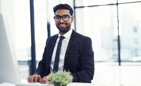 Photo for Think of your competitors as your teachers. a young businessman working on his computer - Royalty Free Image