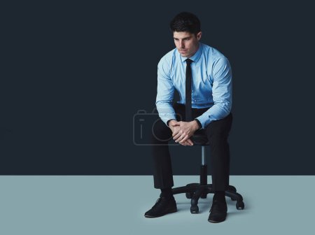 Photo for Your fears are nothing compared to your will to conquer. Studio shot of a young businessman looking thoughtful against a dark background - Royalty Free Image