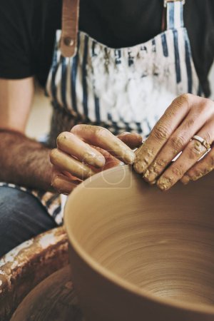 Photo for Craft is beauty created with your hands. an unrecognisable man working with clay in a pottery studio - Royalty Free Image