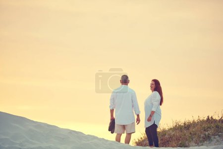 Photo for Couples who vacay together...mature people standing on a sand dune at the beach - Royalty Free Image