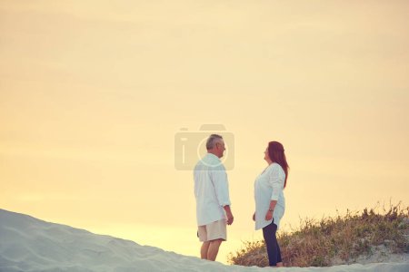 Photo for Spending their retirement wherever the sand is. mature people standing on a sand dune at the beach - Royalty Free Image