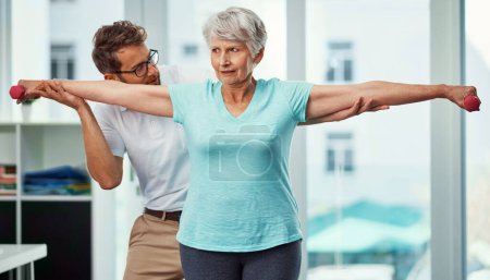 Photo for Hes impressed with her progress. a senior woman working through her recovery with a male physiotherapist - Royalty Free Image