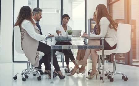 Photo for Teamed up to make success happen. a group of colleagues having a meeting in a modern office - Royalty Free Image