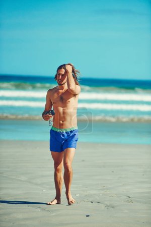Photo for Theres always something to capture at the beach. a young man spending the day at the beach - Royalty Free Image