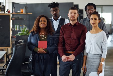 Photo for Were all dedicated to greatness. Portrait of a group of businesspeople standing together in an office - Royalty Free Image