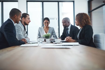 Photo for Teams achieve more in less time. a group of businesspeople having a meeting in the boardroom - Royalty Free Image