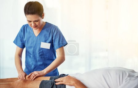 Photo for Lets check out this knee...a young female nurse working through recovery with a senior patient - Royalty Free Image