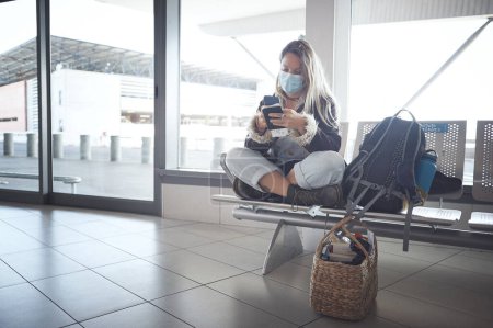 Photo for This is going to be a long day. Shot a young woman sitting with a bags in the airport - Royalty Free Image