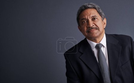 Photo for Work to be nothing less that a success. Studio shot of a mature businessman posing against a dark background - Royalty Free Image