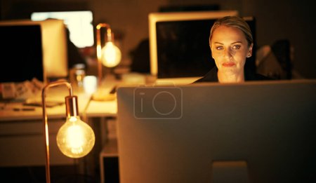 Photo for Working hard on a important project. a mature businesswoman working late at the office - Royalty Free Image