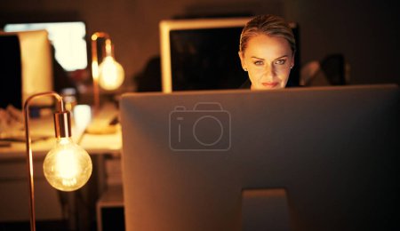 Photo for I wont let any deadline be missed. a mature businesswoman working late at the office - Royalty Free Image