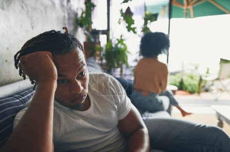 Photo for I think shes being totally petty. a young man looking upset after an argument with his partner at home - Royalty Free Image