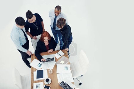Photo for This is our master plan for success. group of businesspeople using a laptop together during a meeting in an office - Royalty Free Image