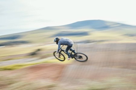 Photo for Sports, energy and man riding a bike in nature training for race, marathon or competition. Fitness, blur motion and male athlete biker practicing for an outdoor cardio exercise, adventure or workout - Royalty Free Image