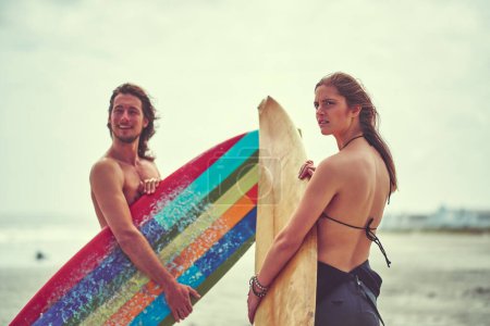Photo for Never fear the wave youre about to ride. a young couple spending the day out surfing - Royalty Free Image