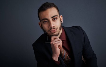 Photo for The thinker. Studio portrait of a stylish young businessman looking thoughtful against a gray background - Royalty Free Image