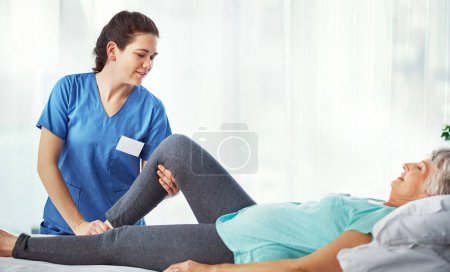Photo for Making sure shes comfortable. a young female carer assisting her senior patient in the hospital - Royalty Free Image
