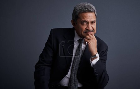 Photo for It took me a while to get to this point. Studio shot of a mature businessman posing against a dark background - Royalty Free Image