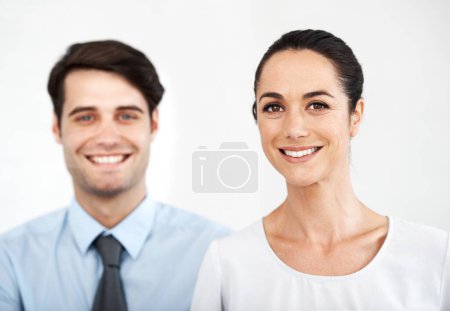 Photo for Positive about their careers. Two young business colleagues standing together while smiling agianst a white background - Royalty Free Image