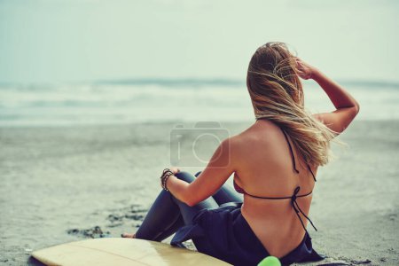 Photo for Where theres a will theres a wave. a beautiful young woman going for a surf at the beach - Royalty Free Image