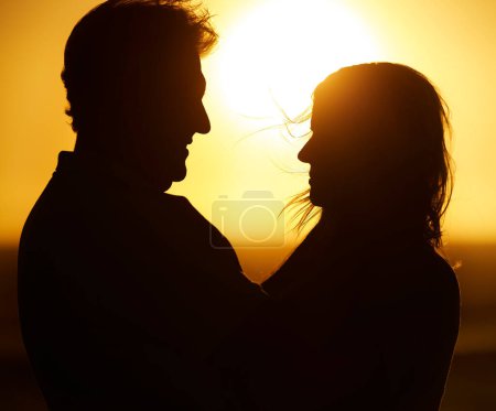 Photo for Silhouette, couple and love at sunset on beach for vacation, holiday or adventure outdoor in nature. Romantic man and woman in marriage with sky background for care, shadow art and travel freedom. - Royalty Free Image