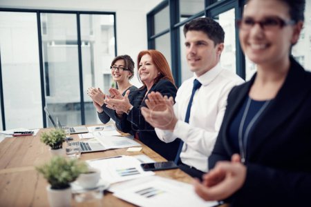 Photo for Were quite impressed. a group of businesspeople applauding while sitting in a boardroom - Royalty Free Image