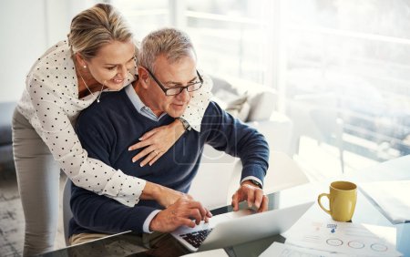 Photo for Enjoying a secure retire thanks to sound financial planning. a mature couple using a laptop while going through paperwork at home - Royalty Free Image