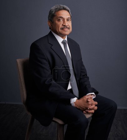 Photo for Never turn down a good opportunity. Studio shot of a mature businessman posing against a dark background - Royalty Free Image